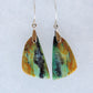 .  Over thousands of years, the woods’ organic material was replaced with opaline silica rich in copper, iron and manganese minerals.  These rich minerals are responsible for the amazing colors in the stone.  The bail and earring wires are authentic 925 sterling silver. 