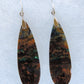 Over thousands of years, the woods’ organic material was replaced with opaline silica rich in copper, iron and manganese minerals.  These rich minerals are responsible for the amazing colors in the stone.  The bail and earring wires are authentic 925 sterling silver.