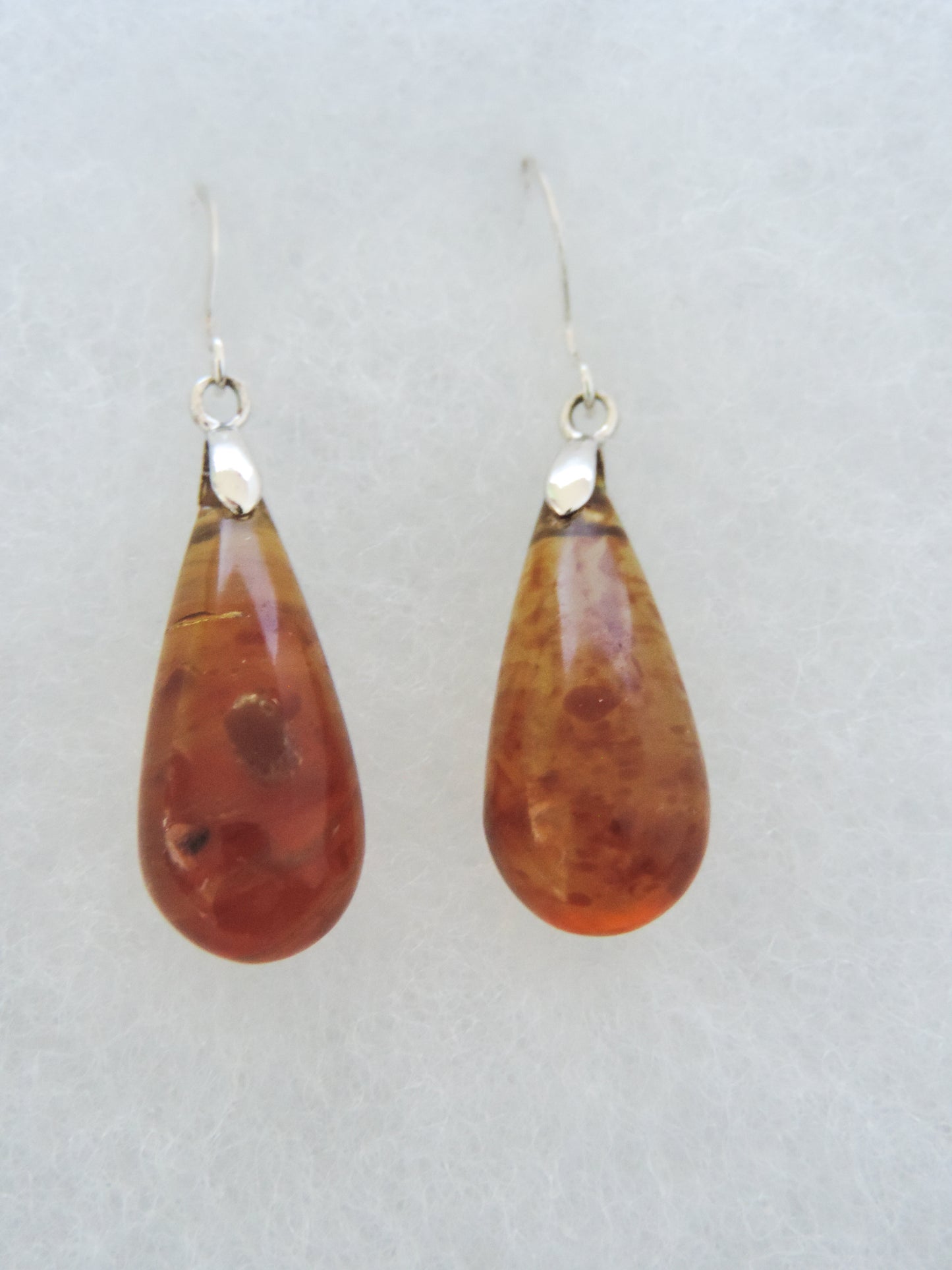 Amber & Sterling Silver Earrings.   These will top off any outfit! Pick a pair of beautiful Amber & Sterling Silver Earrings.   One of a kind, completely unique and hand crafted by an independent master artist!!  The bail and earring wires are authentic 925 sterling silver.