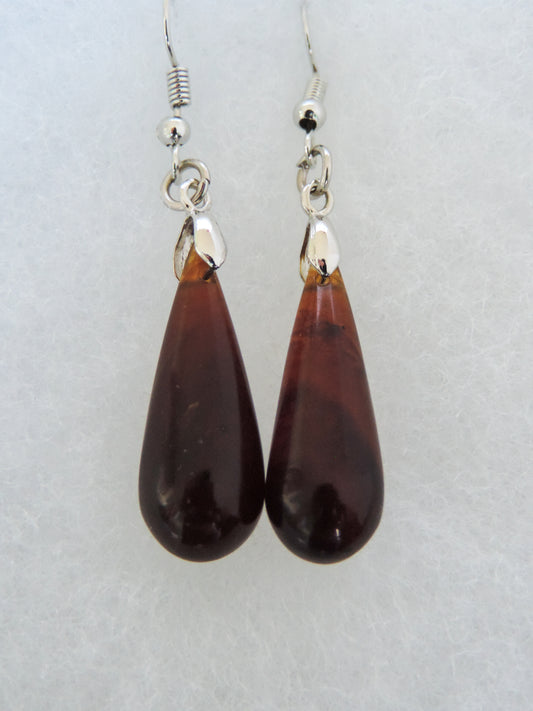 These will top off any outfit! Pick a pair of beautiful Amber & Sterling Silver Earrings.   One of a kind, completely unique and hand crafted by an independent master artist!!  The bail and earring wires are authentic 925 sterling silver.