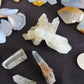 Yellowstone Country Treasure Sampler.  Natural earth items in this sampler package include:  1 large black agatized wood with really nice crystal pocket, $32  1 large petrified wood (rough) $19.75  1 medium petrified/agatized wood (rough) $15.75  2 polished petrified wood (medium) $10.99  3 polished petrified wood (small) $10.99  1 medium madison blue agate, high quality (rough) $7  1 